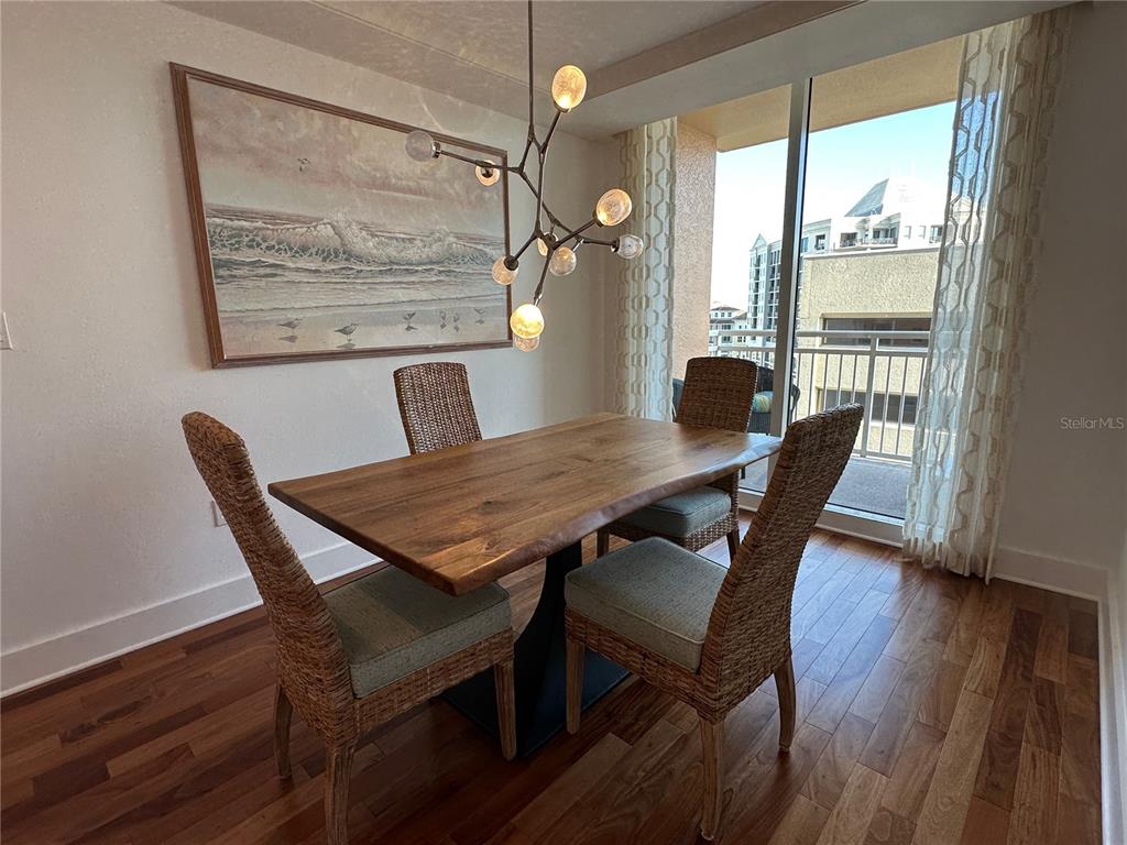 1350 Main Street, Unit 1401 Sarasota, FL 34236 - Photo 15 of 69 a view of a dining room with furniture window and wooden floor
