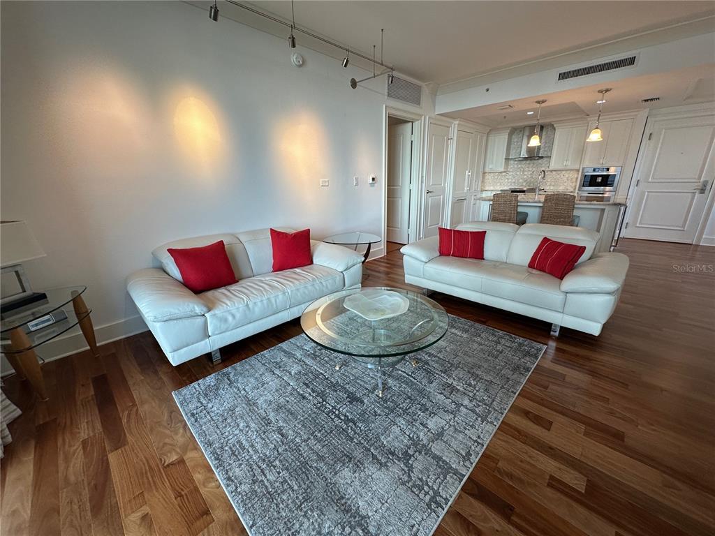 1350 Main Street, Unit 1401 Sarasota, FL 34236 - Photo 32 of 69 a living room with furniture and a wooden floor
