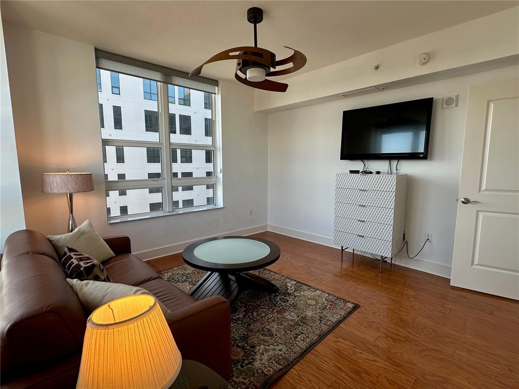 1350 Main Street, Unit 1401 Sarasota, FL 34236 - Photo 35 of 69 a living room with furniture and a flat screen tv