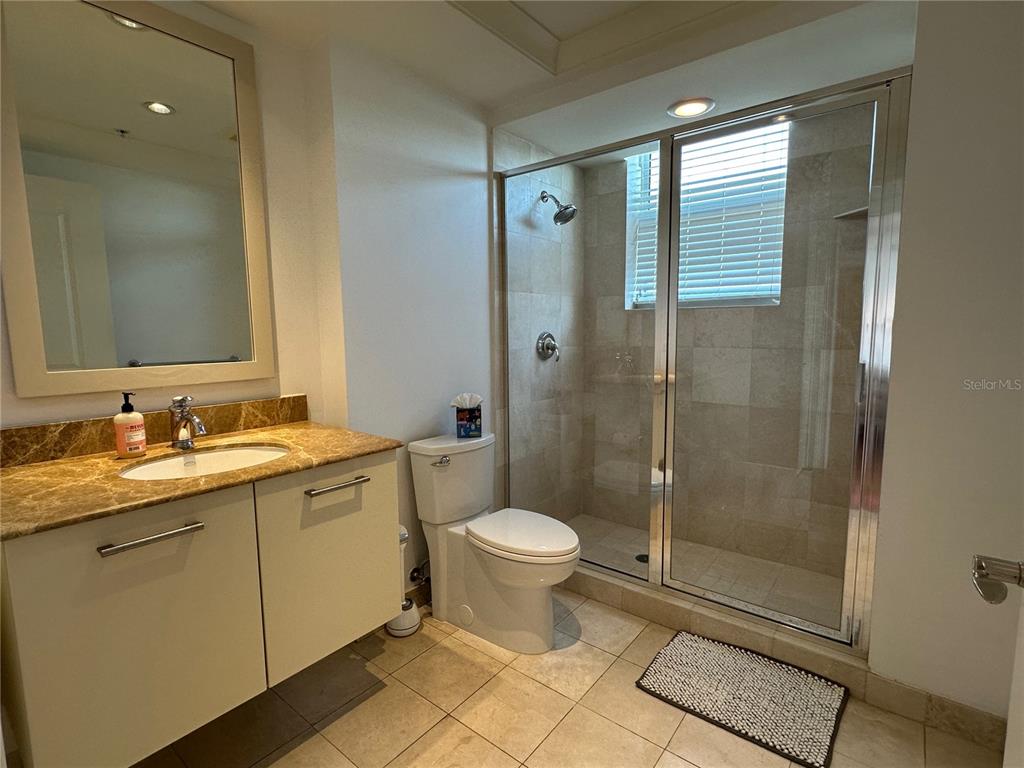 1350 Main Street, Unit 1401 Sarasota, FL 34236 - Photo 37 of 69 a bathroom with a toilet sink and shower