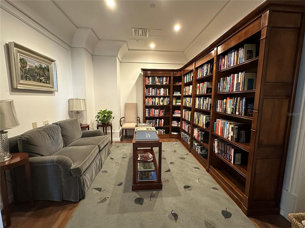 1350 Main Street, Unit 1401 Sarasota, FL 34236 - Photo 64 of 69 a living room with furniture and a book shelf