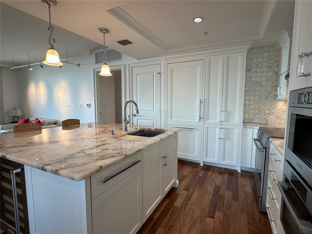 1350 Main Street, Unit 1401 Sarasota, FL 34236 - Photo 7 of 69 a kitchen with sink stove and wooden floor