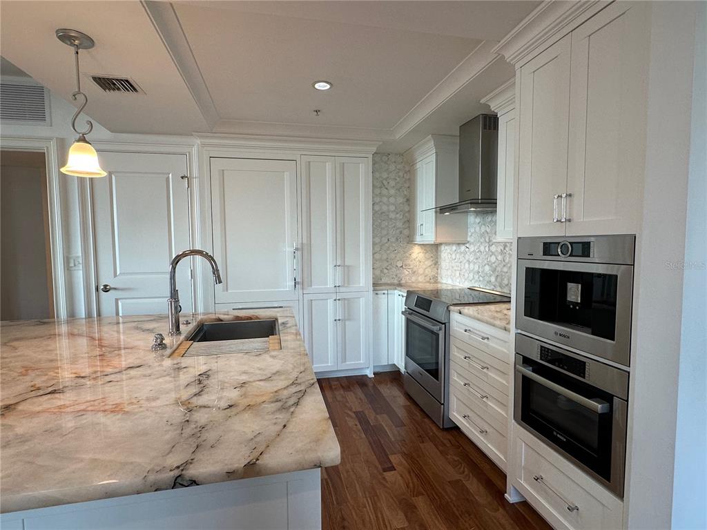 1350 Main Street, Unit 1401 Sarasota, FL 34236 - Photo 10 of 69 a kitchen with sink a stove and oven