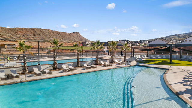 2123 Wolverine Way, Unit 2437 Washington, UT 84780 - Photo 3 of 40 Expansive community pool area featuring a curved leisure pool, additional rectangular lap pool, and multiple sun decks