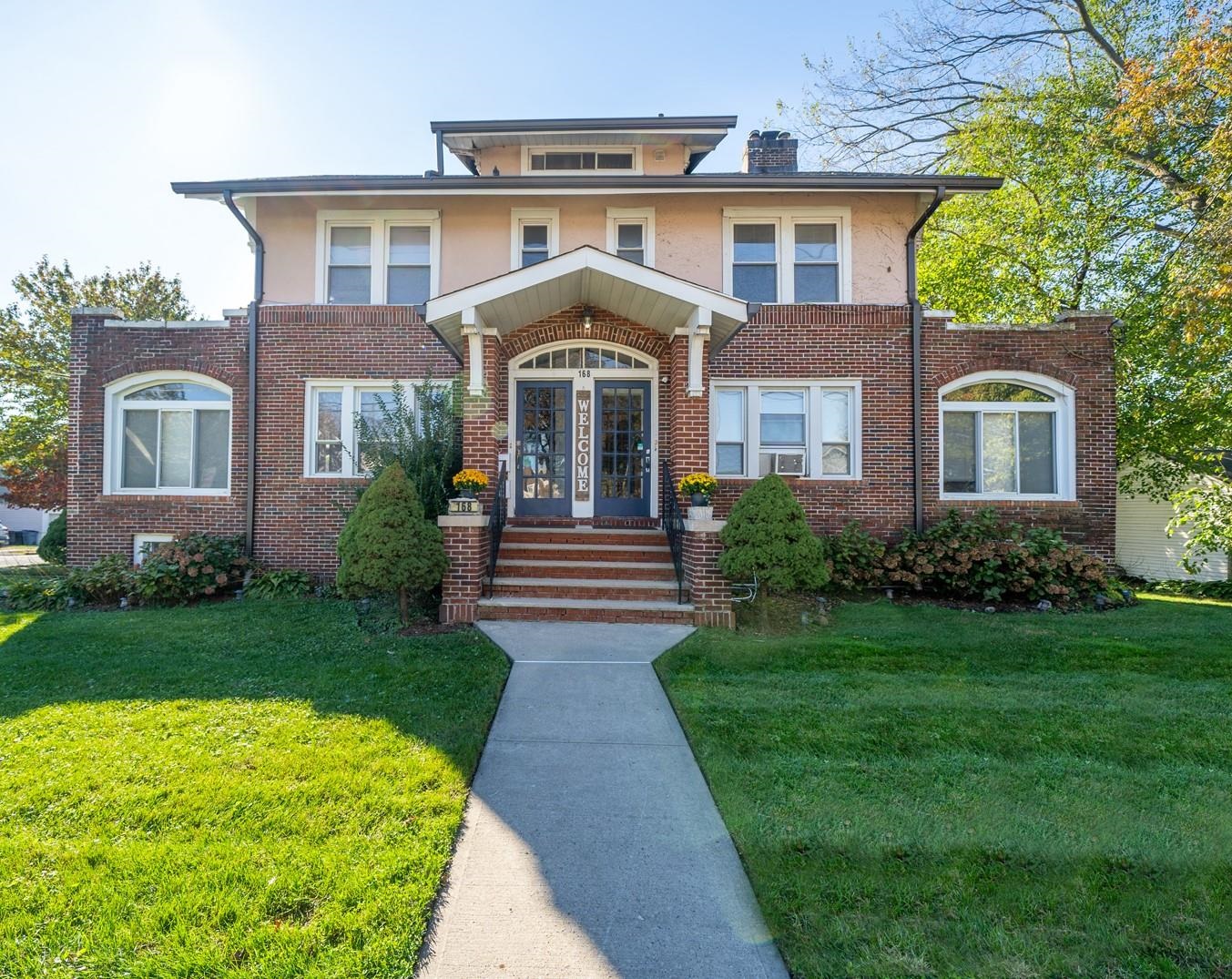 168 West Passaic Street, Unit 2 Maywood, NJ 07607 - Photo 1 of 22 a front view of a house with garden