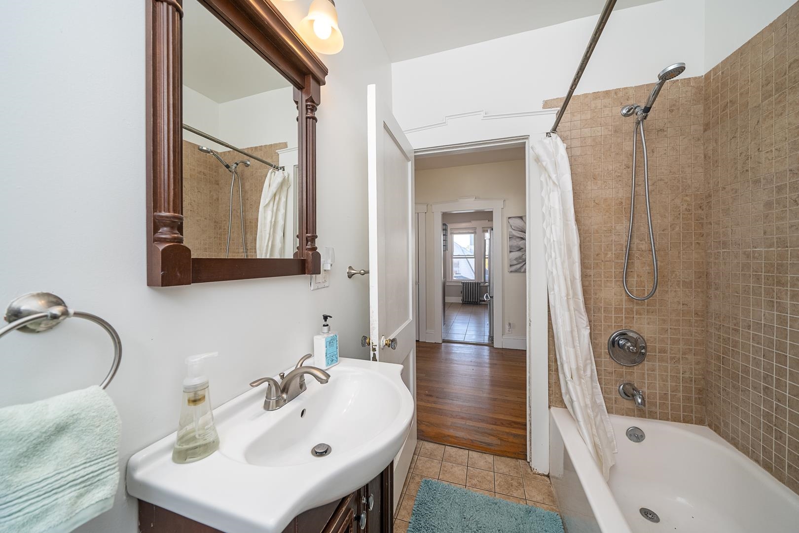 168 West Passaic Street, Unit 2 Maywood, NJ 07607 - Photo 17 of 22 a bathroom with a sink mirror and shower