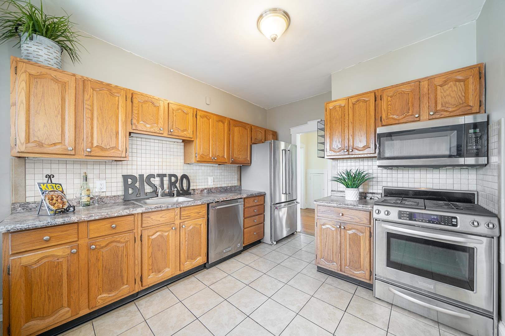 168 West Passaic Street, Unit 2 Maywood, NJ 07607 - Photo 9 of 22 a kitchen with stainless steel appliances granite countertop a stove sink and cabinets