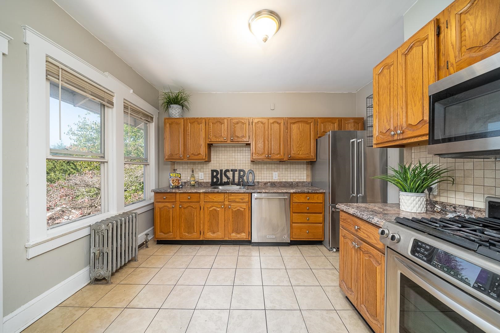 168 West Passaic Street, Unit 2 Maywood, NJ 07607 - Photo 10 of 22 a kitchen with stainless steel appliances granite countertop a stove a sink and a microwave
