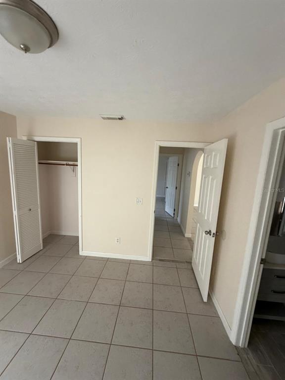 120 Southwest Bedford Road Port St. Lucie, FL 34953 - Photo 21 of 50 a view of a livingroom with an empty space and a hallway