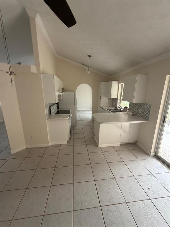 120 Southwest Bedford Road Port St. Lucie, FL 34953 - Photo 30 of 50 a kitchen with stainless steel appliances a sink a counter top space cabinets and a window