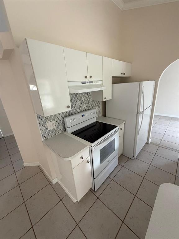 120 Southwest Bedford Road Port St. Lucie, FL 34953 - Photo 33 of 50 a kitchen with cabinets and white appliances