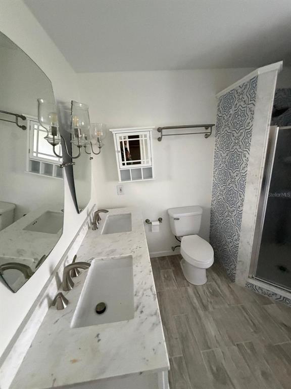 120 Southwest Bedford Road Port St. Lucie, FL 34953 - Photo 41 of 50 a bathroom with a sink a toilet and mirror