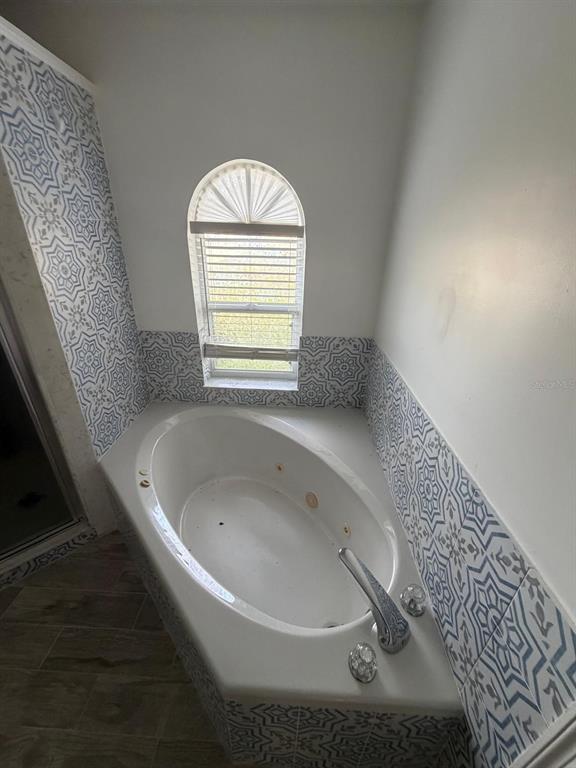 120 Southwest Bedford Road Port St. Lucie, FL 34953 - Photo 42 of 50 a bathroom with a tub sink and window