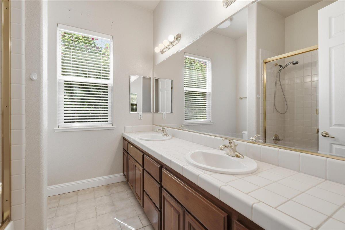 4129 Poppleton Way Carmichael, CA 95608 - Photo 42 of 48 a bathroom with a granite countertop sink and a mirror