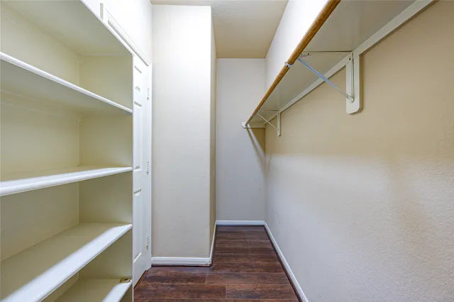 a view of a room with wooden floor and white walls