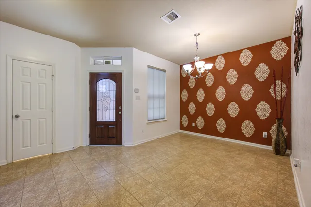 a view of a chandelier fan and refrigerator