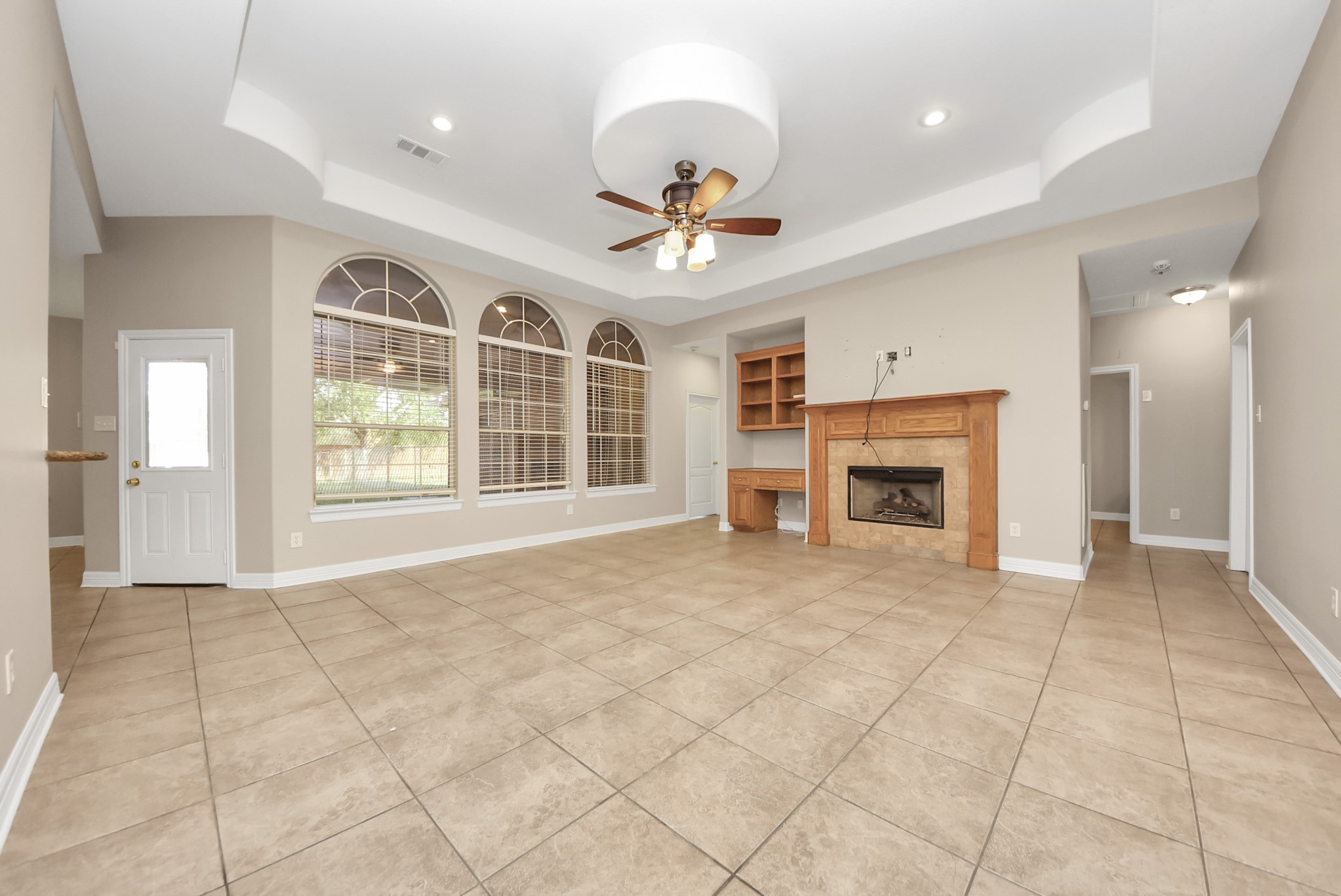 4320 Barkaloo Road Baytown, TX 77521 - Photo 14 of 28 a view of an empty room with a fireplace and a ceiling fan