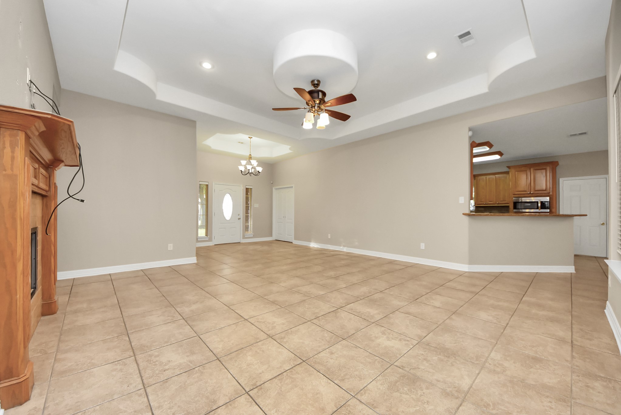 4320 Barkaloo Road Baytown, TX 77521 - Photo 16 of 28 a view of a livingroom with a chandelier furniture and a ceiling fan