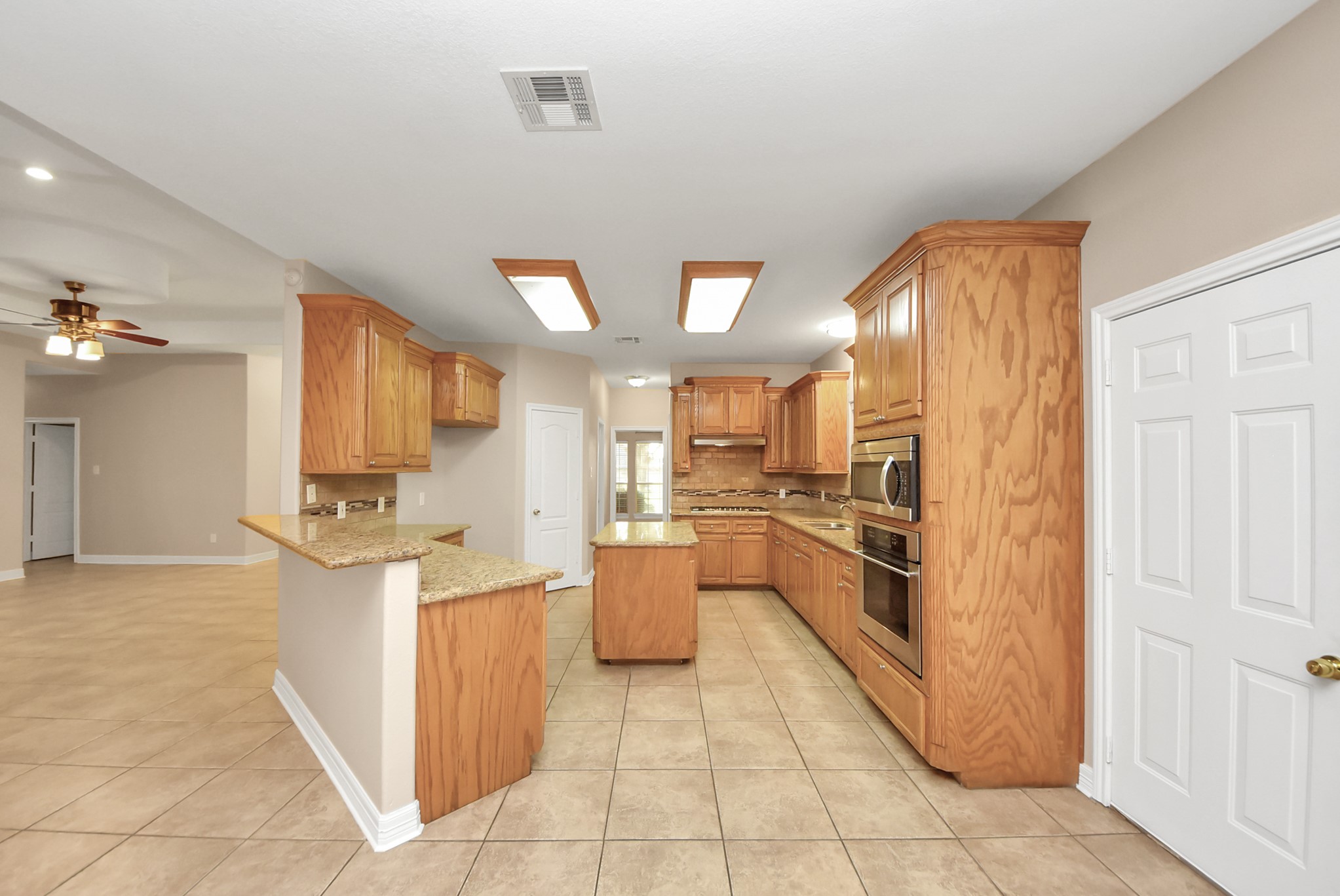 4320 Barkaloo Road Baytown, TX 77521 - Photo 21 of 28 a kitchen with stainless steel appliances granite countertop a refrigerator and a stove top oven