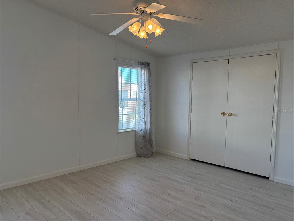 1622 Southwest 35th Circle Okeechobee, FL 34974 - Photo 12 of 19 wooden floor in an empty room with a window