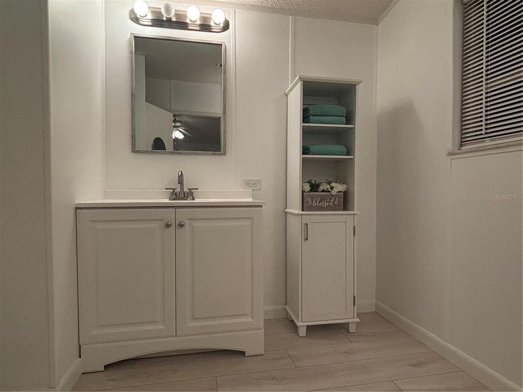 1622 Southwest 35th Circle Okeechobee, FL 34974 - Photo 14 of 19 a bathroom with a sink and a mirror