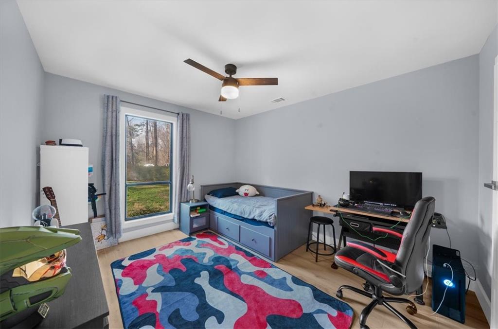 5802 Bay Pointe Sound Acworth, GA 30101 - Photo 20 of 41 a bedroom with a bed and a chandelier