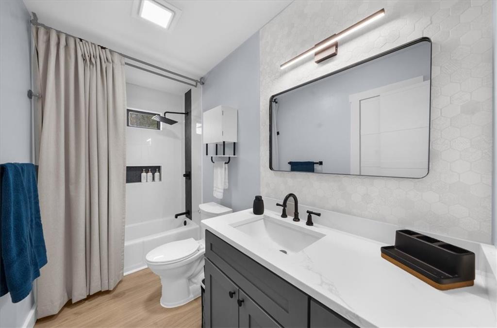 5802 Bay Pointe Sound Acworth, GA 30101 - Photo 22 of 41 a bathroom with a toilet sink a mirror and shower