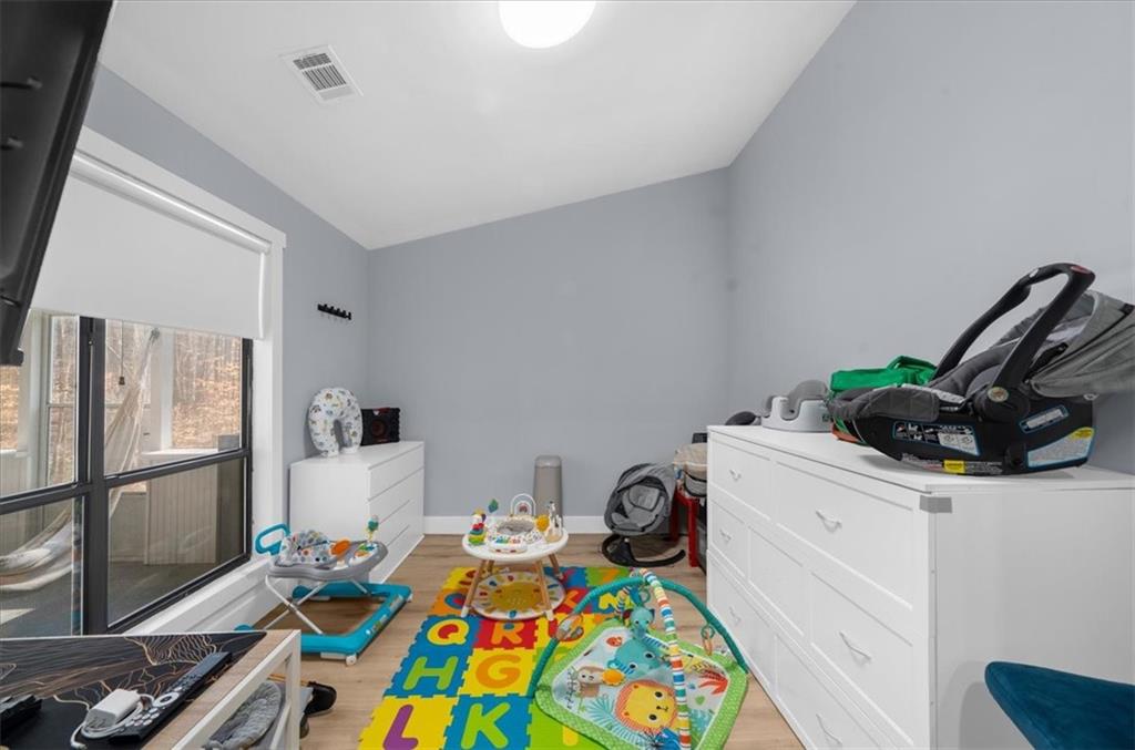 5802 Bay Pointe Sound Acworth, GA 30101 - Photo 23 of 41 a room that has a bed and a dresser in it