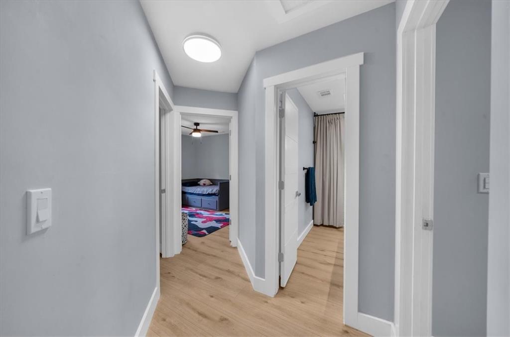 5802 Bay Pointe Sound Acworth, GA 30101 - Photo 26 of 41 a view of a hallway with wooden floor and a livingroom with a bathroom
