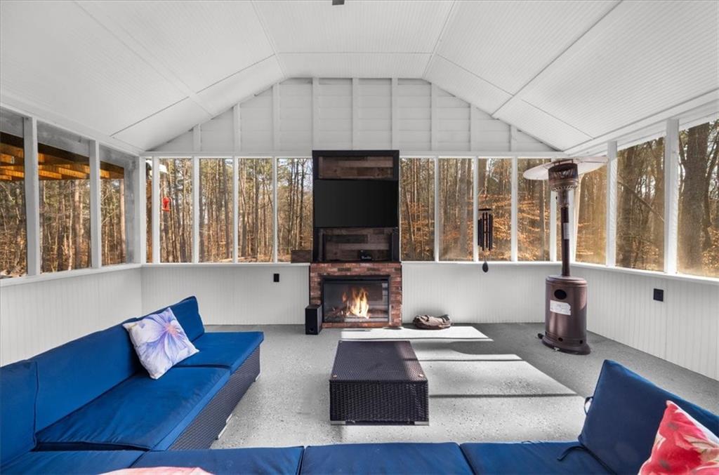 5802 Bay Pointe Sound Acworth, GA 30101 - Photo 27 of 41 a living room with furniture fireplace and flat screen tv
