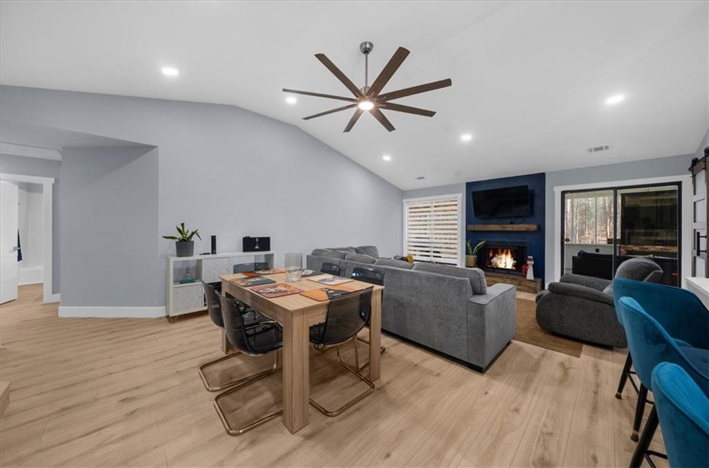5802 Bay Pointe Sound Acworth, GA 30101 - Photo 9 of 41 a living room with furniture a fireplace and a flat screen tv