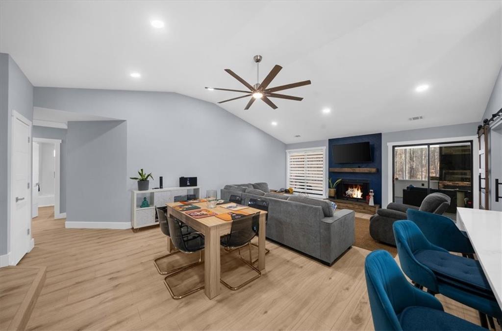 5802 Bay Pointe Sound Acworth, GA 30101 - Photo 10 of 41 a living room with furniture a fireplace and a flat screen tv