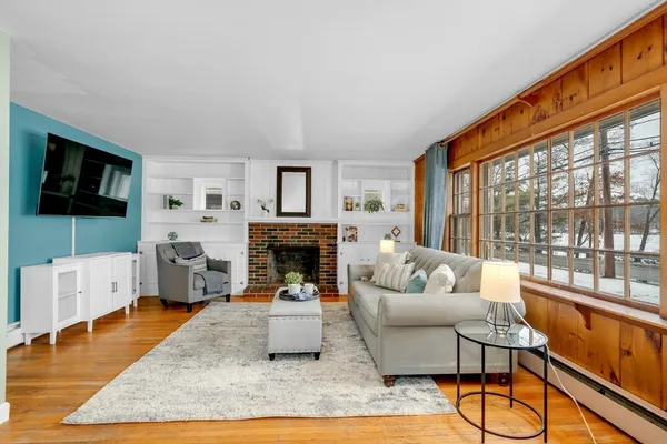 a living room with furniture a flat screen tv and a fireplace