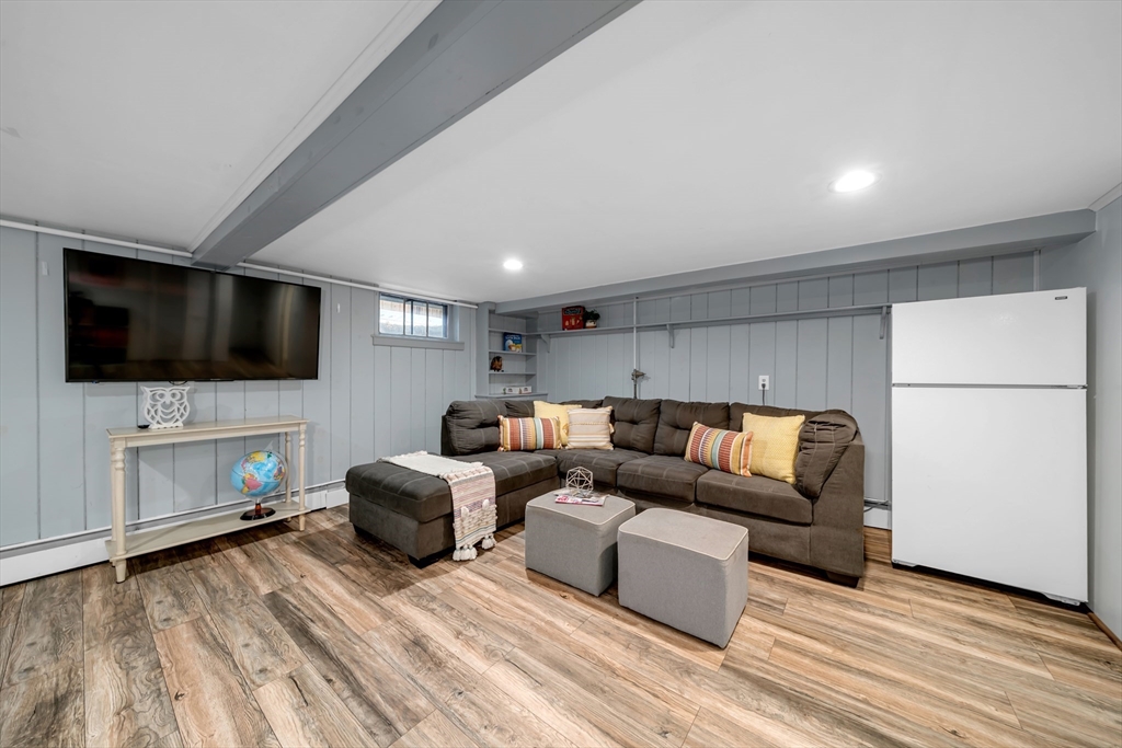 69 Pond Street Georgetown, MA 01833 - Photo 21 of 30 a living room with fireplace furniture and a flat screen tv