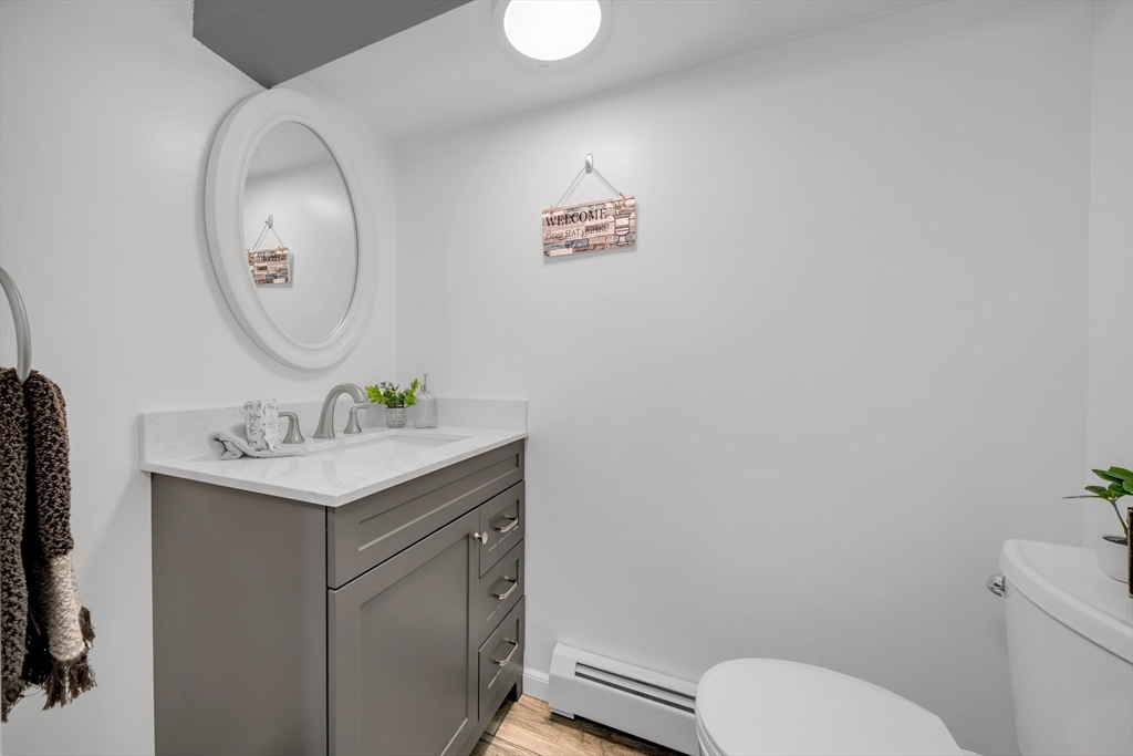 69 Pond Street Georgetown, MA 01833 - Photo 22 of 30 a bathroom with a toilet a sink and a mirror
