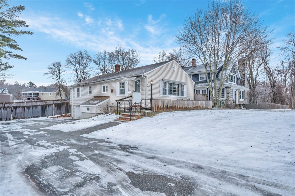 69 Pond Street Georgetown, MA 01833 - Photo 25 of 30 a view of a house with a yard covered in snow