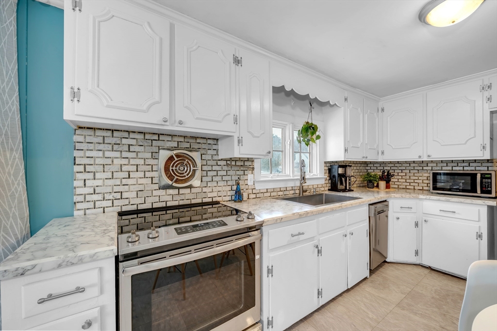 69 Pond Street Georgetown, MA 01833 - Photo 8 of 30 a kitchen with white cabinets and appliances