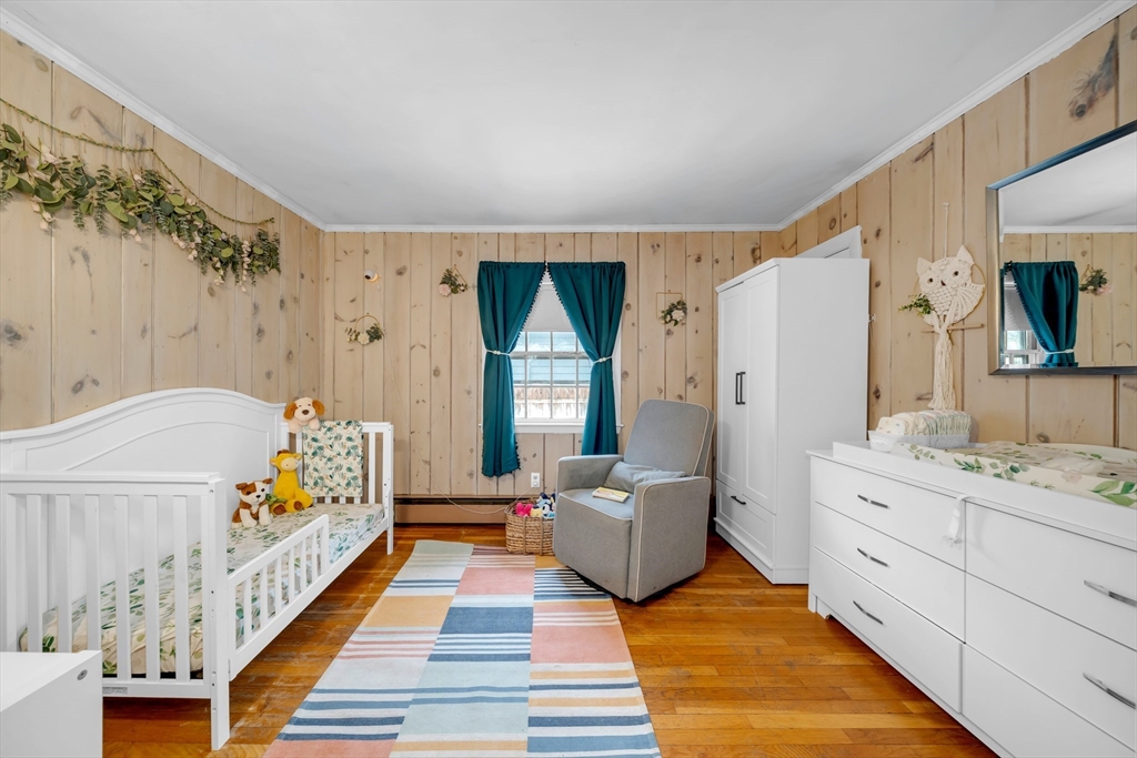 69 Pond Street Georgetown, MA 01833 - Photo 10 of 30 a spacious bedroom with a bed and a mirror