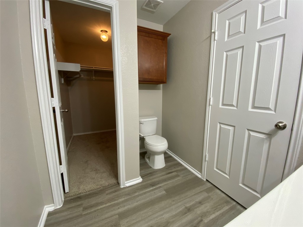 304 Azurite Drive Jarrell, TX 76537 - Photo 17 of 24 Bathroom featuring a spacious closet and light wood-style flooring
