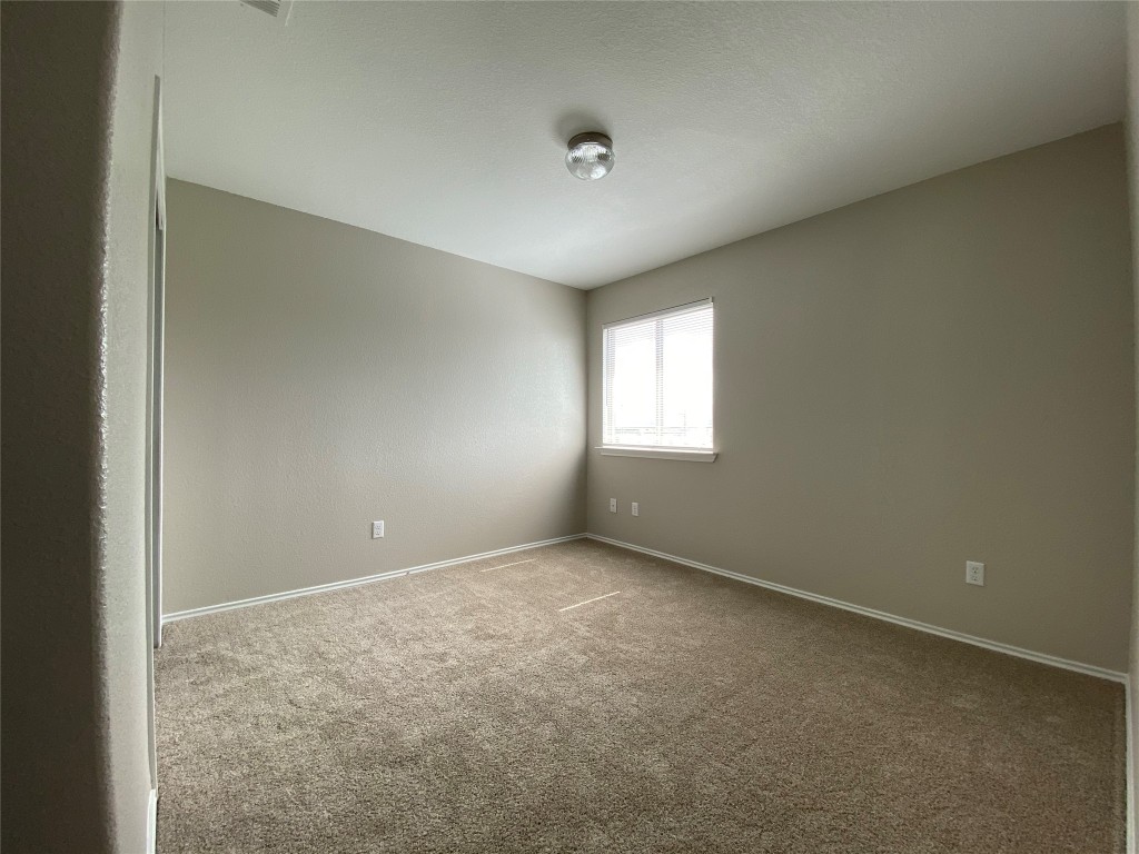 304 Azurite Drive Jarrell, TX 76537 - Photo 5 of 24 Empty room featuring carpet flooring and baseboards