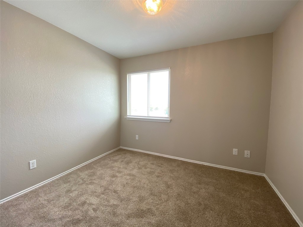 304 Azurite Drive Jarrell, TX 76537 - Photo 6 of 24 Empty room with carpet flooring and baseboards