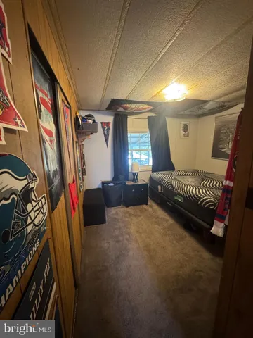 a view of a bedroom with a large bed and furniture