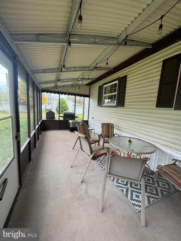 a building outdoor space with patio furniture and a potted plant