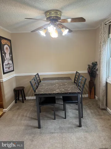 a view of a room with a table and chairs