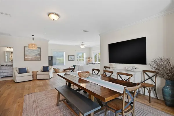 a dining room with furniture and wooden floor