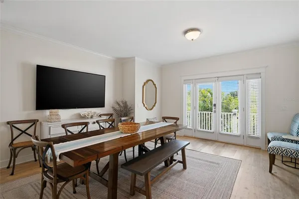 a kitchen with stainless steel appliances granite countertop a table chairs refrigerator and sink