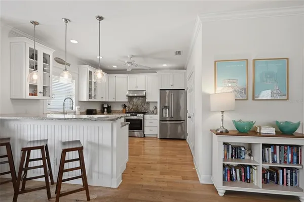 a kitchen with white cabinets and stainless steel appliances