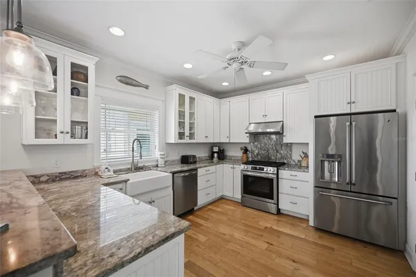 a kitchen with granite countertop a sink and a window