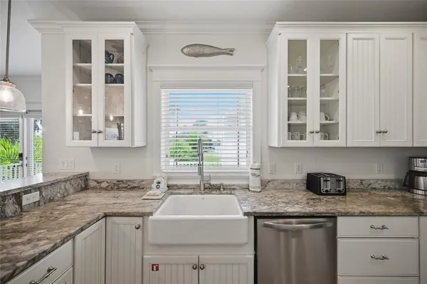 a living room with furniture chandelier and a window