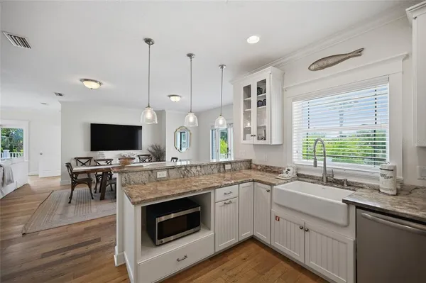 a living room with furniture a large window and a flat screen tv
